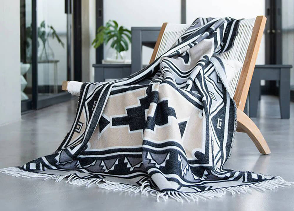 Thula Tula cotton blanket throw is lying on the chair