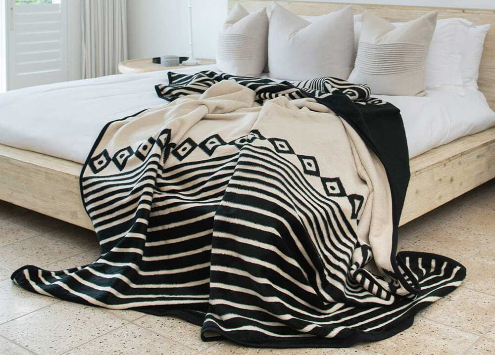 Xhosa black and bone blanket spread on the bed