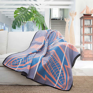 Heirloom Basotho Wool Blanket - Cobalt Yolk Natural lying on sofa