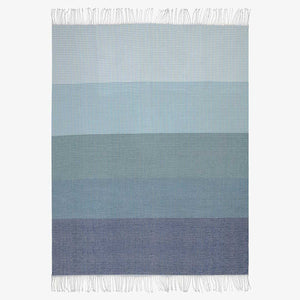 Top View on white background of lyric collection blue and white wrap, blanket or throw sustainably and ethically made in South Africa shows the intricate weave and color
