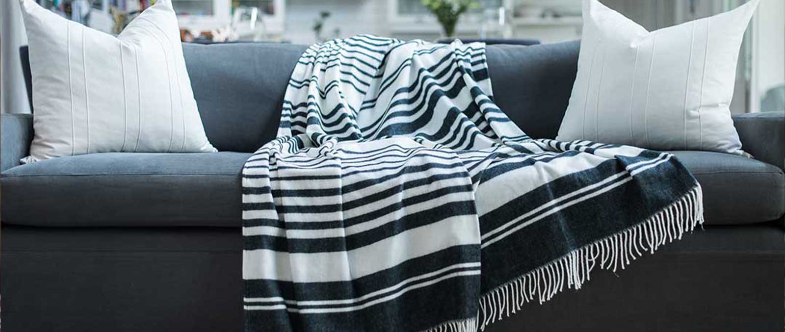 Xhosa Tribal african black and white striped blanket lying on a couch in African home 