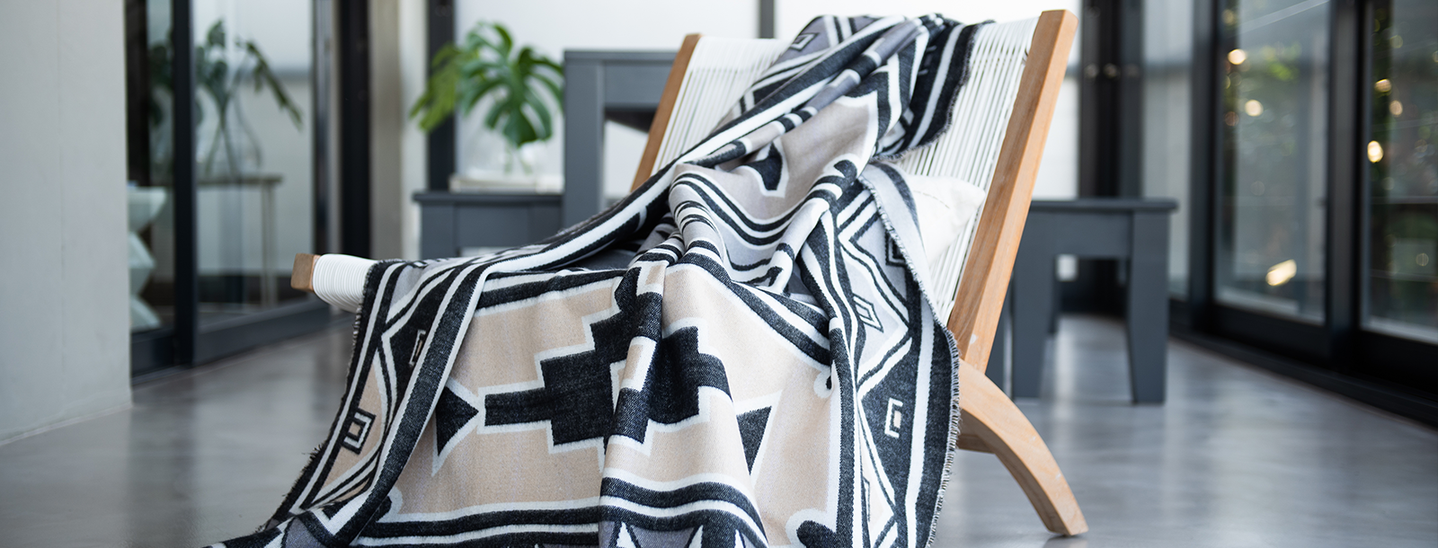The Difference Between a Blanket and a Throw Ndebele Nation design drapped over chair in modern house