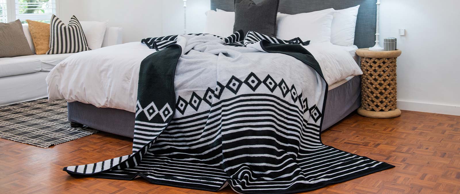 Thula Tula black and white blanket is placed on the bed