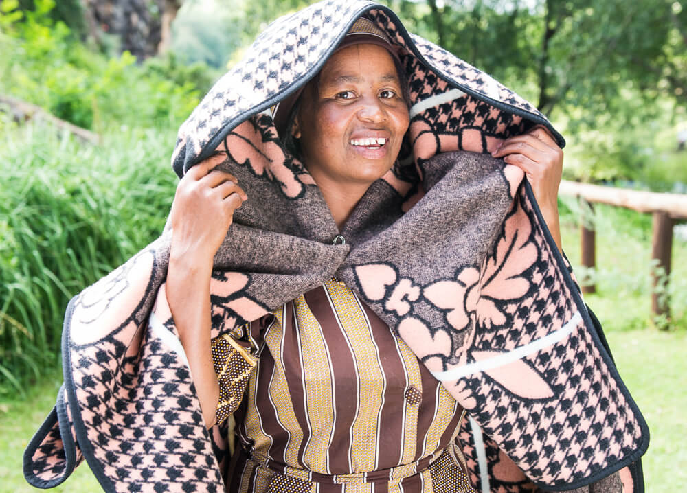 A woman is wrapped with  wearable blanket