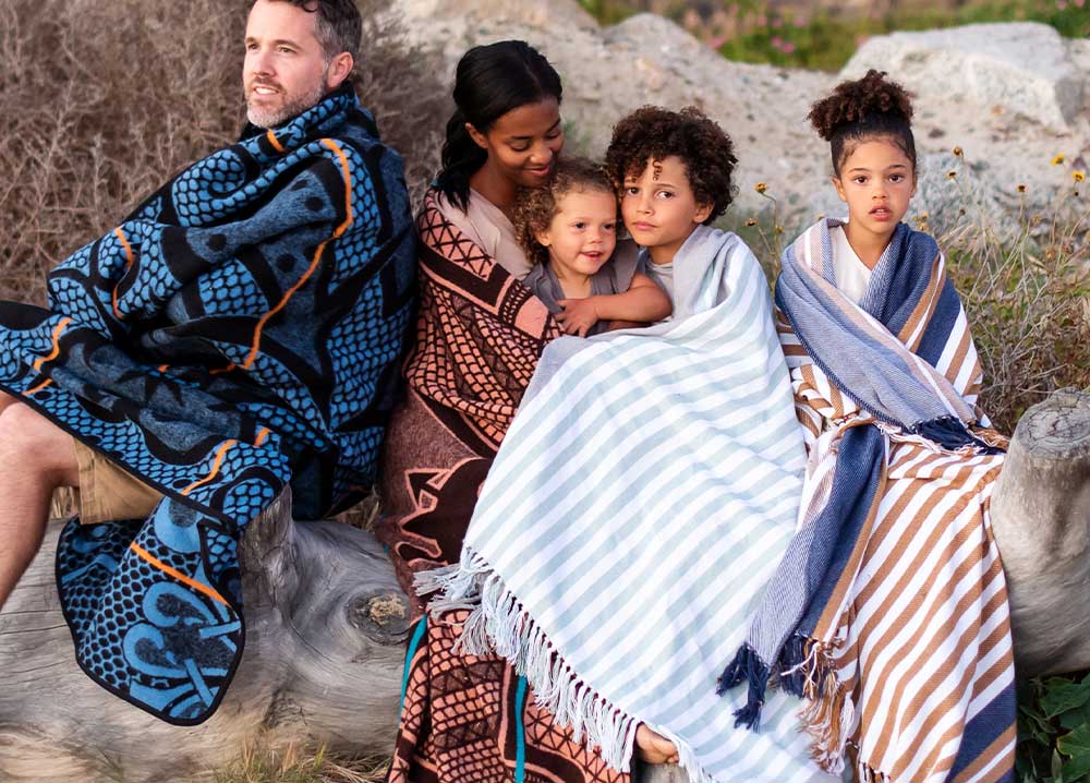 A family is in the outing and wrapped with thula tula blankets and throws