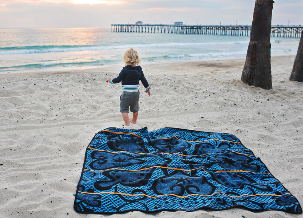 baby  on beach blanket by Thula Tula