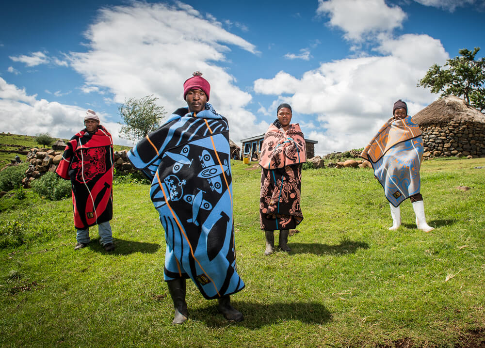 basotho people are standing in wearable different colors wool blanket