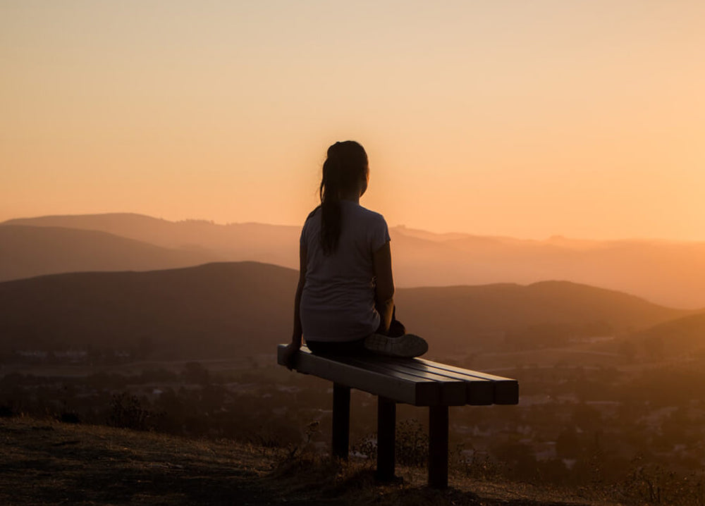 girl sitting on meditation bench