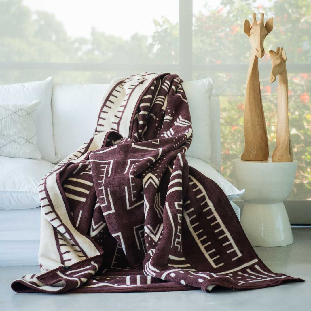 Mali cotton suede Mud Cloth wrap, blanket or throw sustainably and ethically made in South Africa draped over a modern House in South African home 