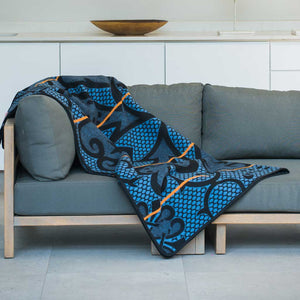 Authentic SeannaMarena Basotho Heritage Wool Blanket and wrap or throw sustainably and ethically crafted in South Africa draped over modern house in South Africa 