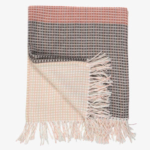 ﻿a lyric collection read and black wrap, blanket or throw sustainably and ethically made in South Africa shows the intricate weave and colors folded up on white background 