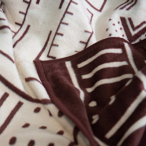 Extreme cloeup view of the  Mali cotton suede Mud Cloth wrap, blanket or throw sustainably and ethically made in South Africa that shows the blanket intricate design