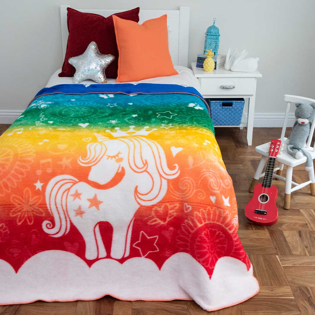 Kids African Magic Unicorn Blanket laying on bed red