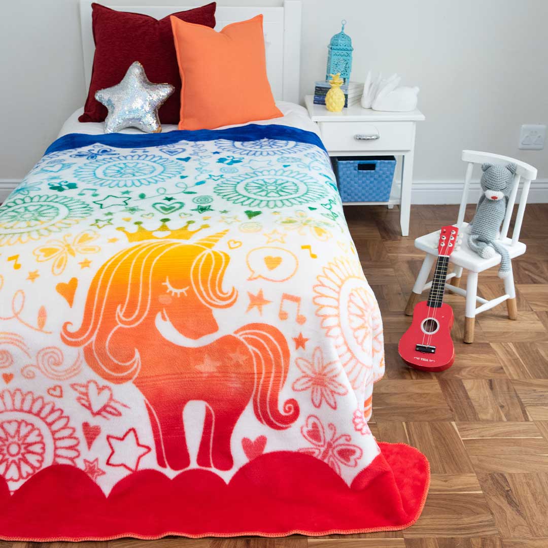 Kids African Magic Unicorn Blanket laying on bed red