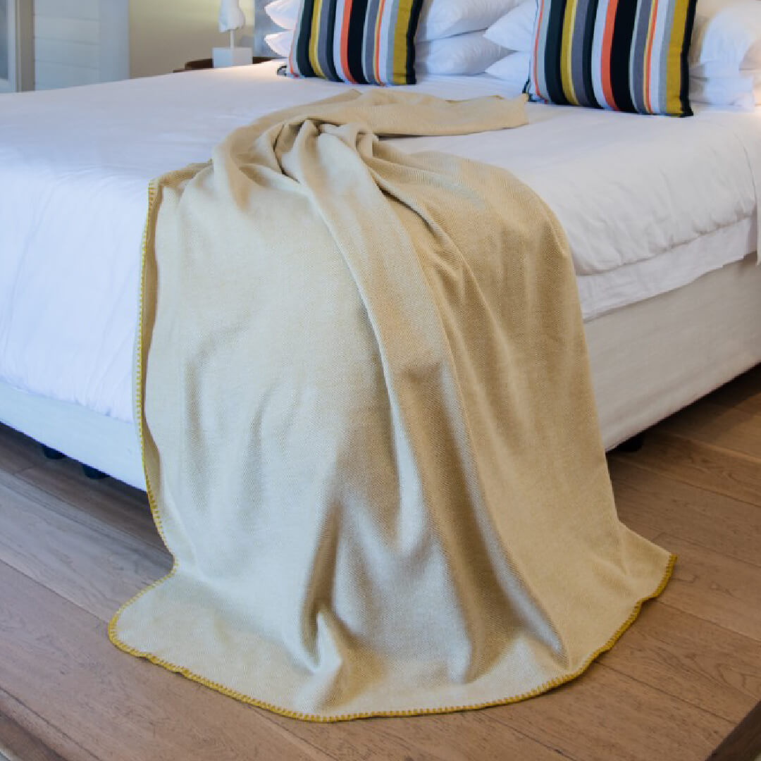 Winter Herringbone Blanket Gold and Natural  laying on bed