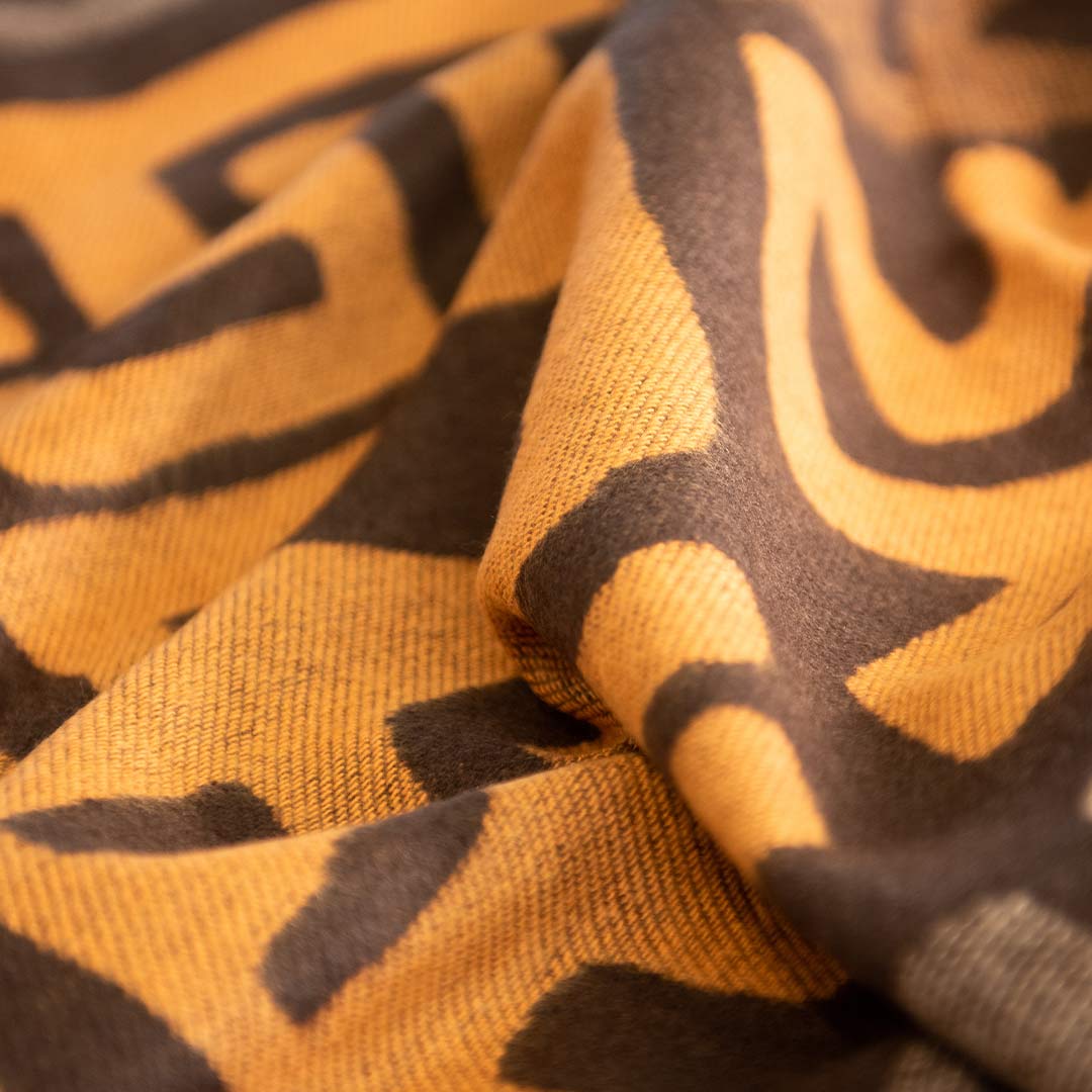 Extreme Close up of  soft African inspired designed Congolese kuba cloth wrap or blanket handmade in South Africa. The close up shows the color african design and tight weave 